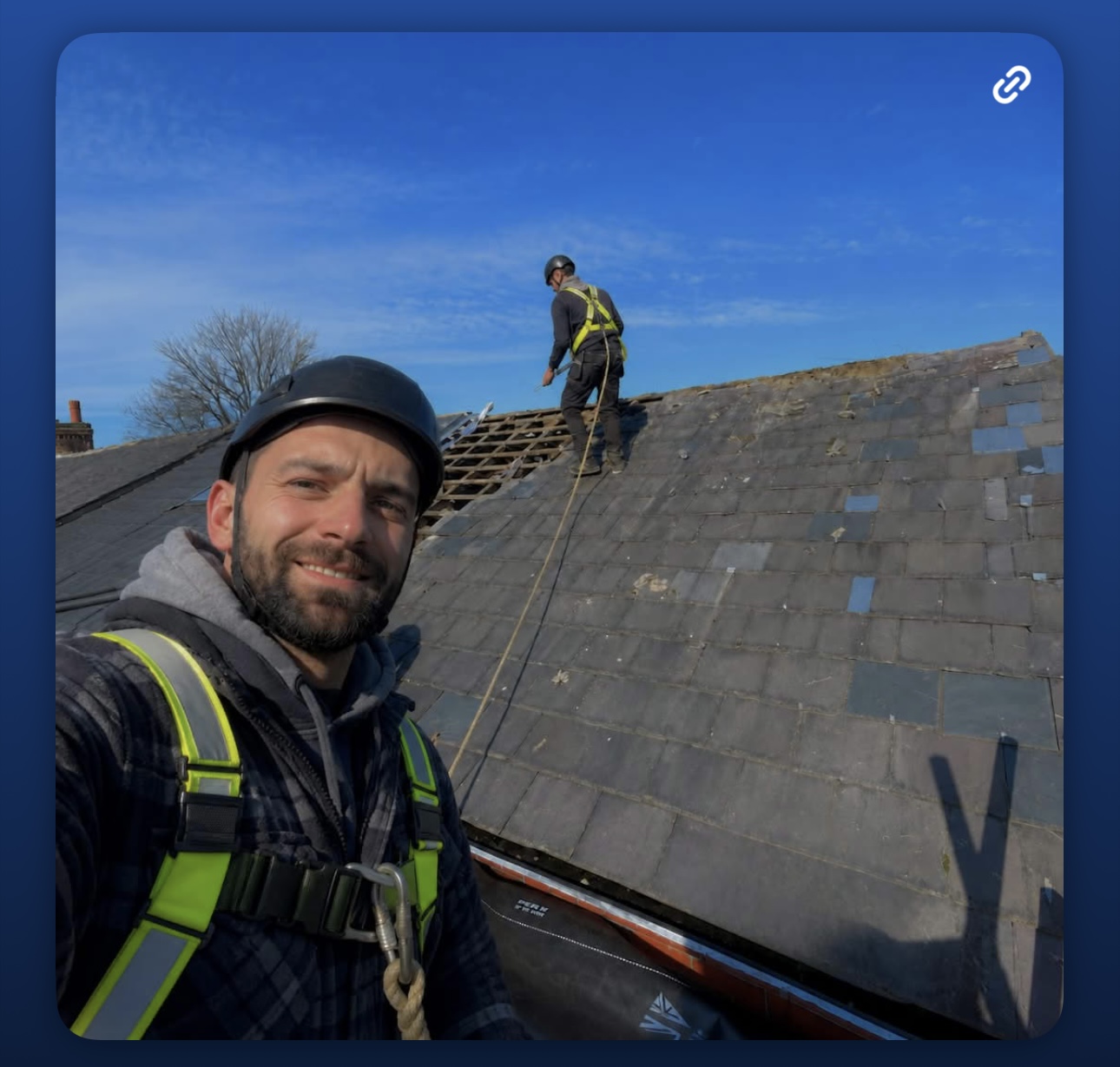Roofing team working on a slate roof